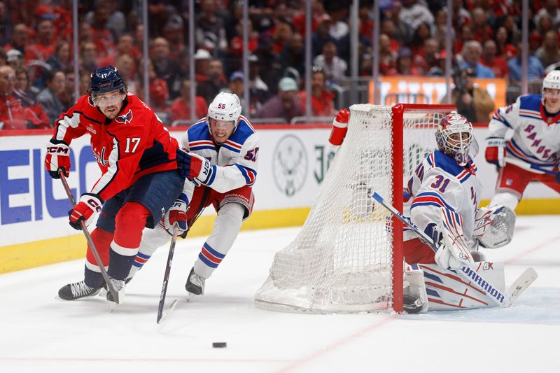 Apr 28, 2024; Washington, District of Columbia, USA; Washington Capitals center Dylan Strome (17) passes the puck behind New York Rangers goaltender Igor Shesterkin (31) as Rangers defenseman Ryan Lindgren (55) defends in the third period in game four of the first round of the 2024 Stanley Cup Playoffs at Capital One Arena. Mandatory Credit: Geoff Burke-USA TODAY Sports