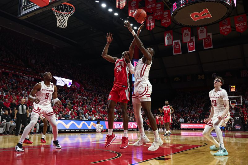 Mar 10, 2024; Piscataway, New Jersey, USA; Ohio State Buckeyes center Felix Okpara (34) rebounds against Rutgers Scarlet Knights center Clifford Omoruyi (11) during the second half at Jersey Mike's Arena. Mandatory Credit: Vincent Carchietta-USA TODAY Sports