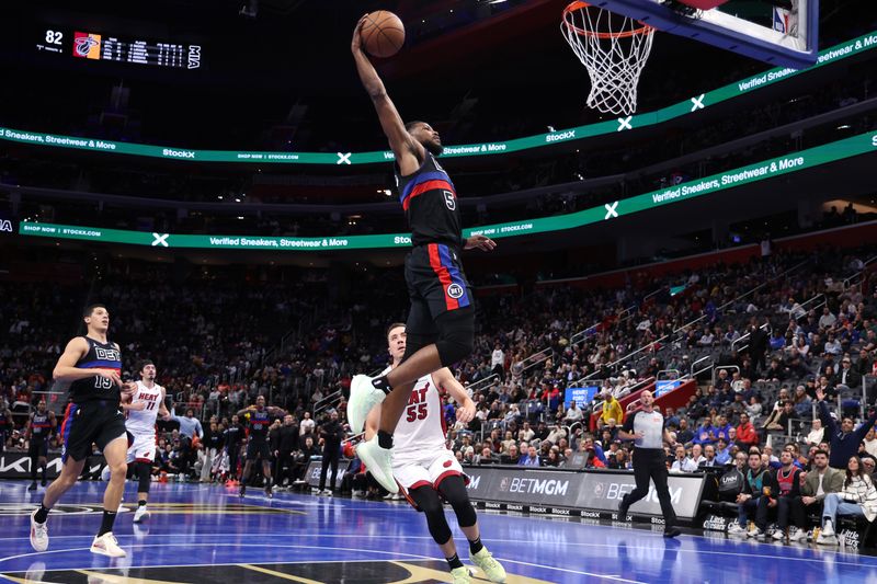 DETROIT, MICHIGAN - NOVEMBER 12: Malik Beasley #5 of the Detroit Pistons dunks in front of Duncan Robinson #55 of the Miami Heat during the second half in the first round of the Emirates NBA Cup at Little Caesars Arena on November 12, 2024 in Detroit, Michigan. NOTE TO USER: User expressly acknowledges and agrees that, by downloading and or using this photograph, User is consenting to the terms and conditions of the Getty Images License. (Photo by Gregory Shamus/Getty Images)