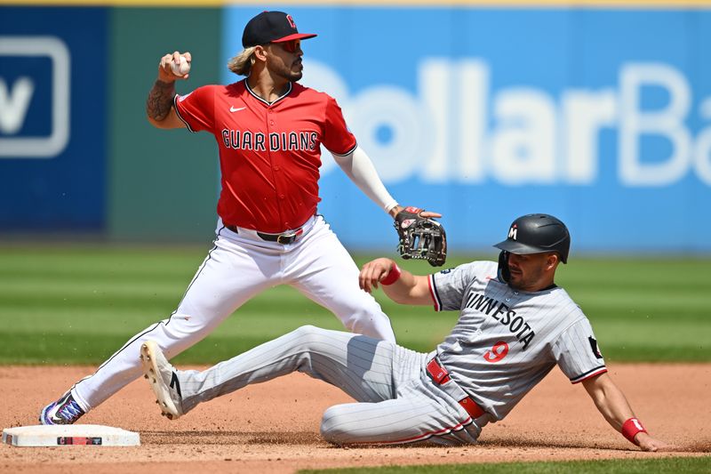 Aug 3, 2025; Cleveland, Ohio, USA; Cleveland Guardians shortstop Gabriel Arias (13) forces out Minnesota Twins left fielder Trevor Larnach (9) during the fourth inning at Progressive Field. Mandatory Credit: Ken Blaze-Imagn Images