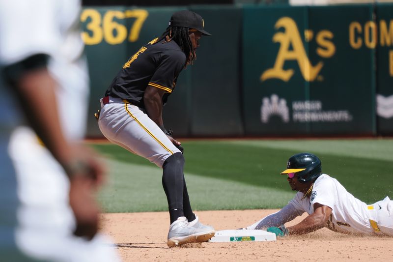 May 1, 2024; Oakland, California, USA; Oakland Athletics center fielder Esteury Ruiz (1) steals second base against Pittsburgh Pirates shortstop Oneil Cruz (15) during the eighth inning at Oakland-Alameda County Coliseum. Mandatory Credit: Kelley L Cox-USA TODAY Sports