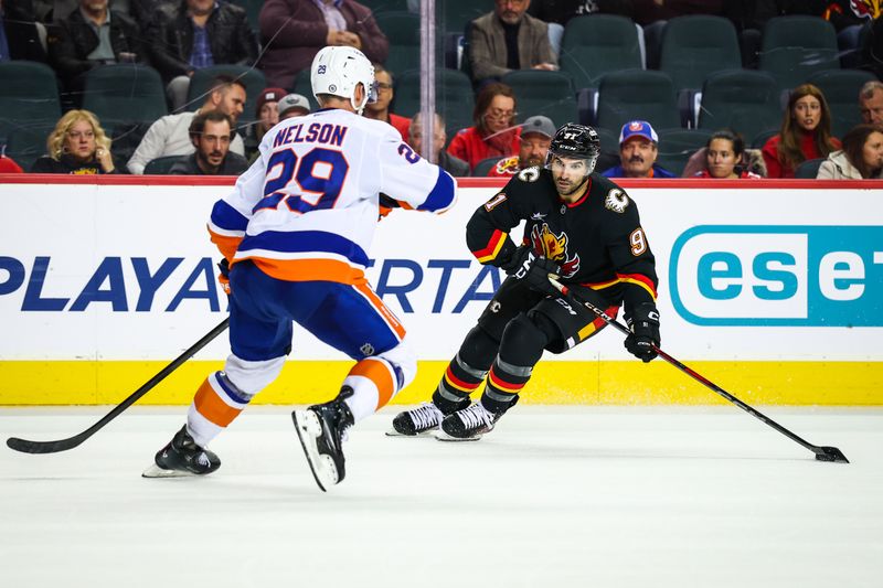 Nov 19, 2024; Calgary, Alberta, CAN; Calgary Flames center Nazem Kadri (91) skates with the puck against the New York Islanders during the overtime period at Scotiabank Saddledome. Mandatory Credit: Sergei Belski-Imagn Images