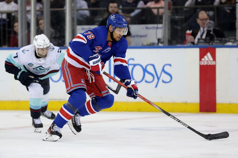 Jan 16, 2024; New York, New York, USA; New York Rangers defenseman K'Andre Miller (79) brings the puck up ice against Seattle Kraken right wing Jordan Eberle (7) during the third period at Madison Square Garden. Mandatory Credit: Brad Penner-USA TODAY Sports