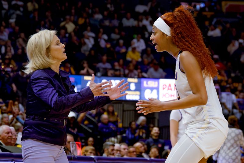 Feb 22, 2024; Baton Rouge, Louisiana, USA; LSU Lady Tigers head coach Kim Mulkey, left, and LSU Lady Tigers forward Angel Reese  talk during the second half against the Auburn Tigers at Pete Maravich Assembly Center. Mandatory Credit: Matthew Hinton-USA TODAY Sports