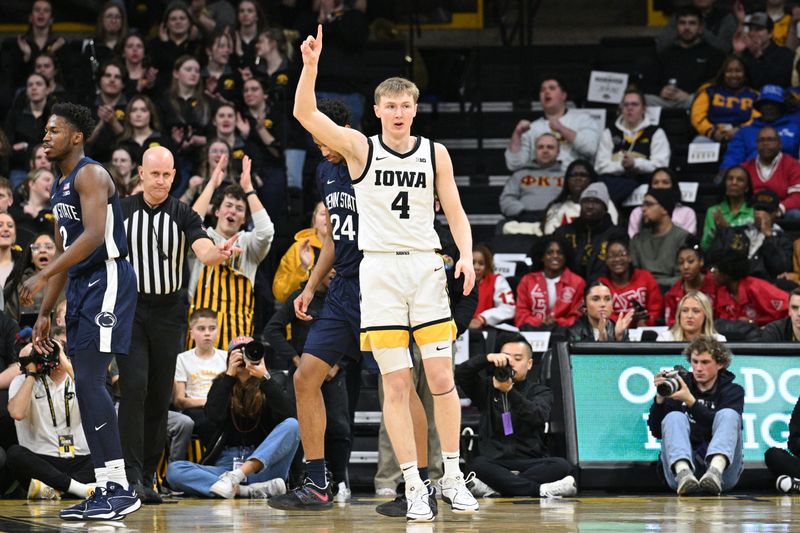 Feb 27, 2024; Iowa City, Iowa, USA; Iowa Hawkeyes guard Josh Dix (4) reacts as Penn State Nittany Lions guard D'Marco Dunn (2) looks on during the first half at Carver-Hawkeye Arena. Mandatory Credit: Jeffrey Becker-USA TODAY Sports