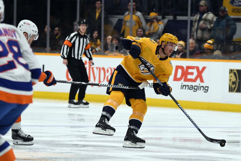 Jan 13, 2024; Nashville, Tennessee, USA; Nashville Predators center Gustav Nyquist (14) passes the puck into the offensive zone during the first period against the New York Islanders at Bridgestone Arena. Mandatory Credit: Christopher Hanewinckel-USA TODAY Sports