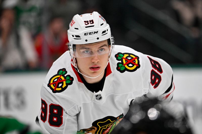 Oct 26, 2024; Dallas, Texas, USA; Chicago Blackhawks center Connor Bedard (98) looks on during a face-off with the Dallas Stars during the first period at the American Airlines Center. Mandatory Credit: Jerome Miron-Imagn Images