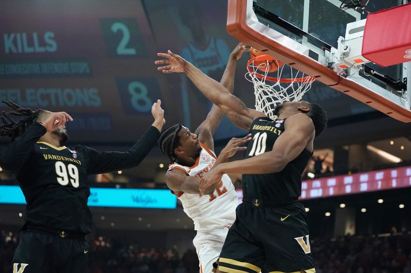 Jan 14, 2026; Austin, Texas, USA; Texas Longhorns guard Tramon Mark (12) dunks the ball against Vanderbilt Commodores forward Devin McGlockton (99) and forward AK Okereke (10) during the first half at Moody Center. Mandatory Credit: Dustin Safranek-Imagn Images