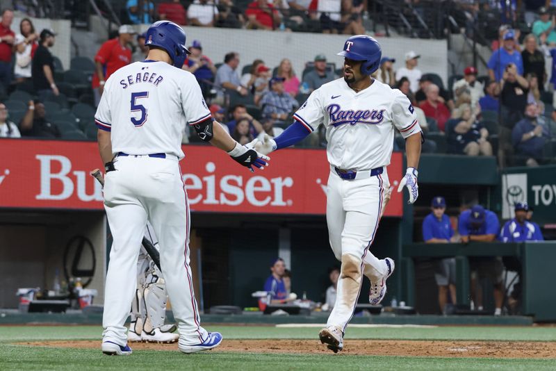 Jul 25, 2024; Arlington, Texas, USA; Texas Rangers second base Marcus Semien (2) celebrates with shortstop Corey Seager (5) after hitting a home run against the Chicago White Sox in the third inning at Globe Life Field. Mandatory Credit: Tim Heitman-USA TODAY Sports