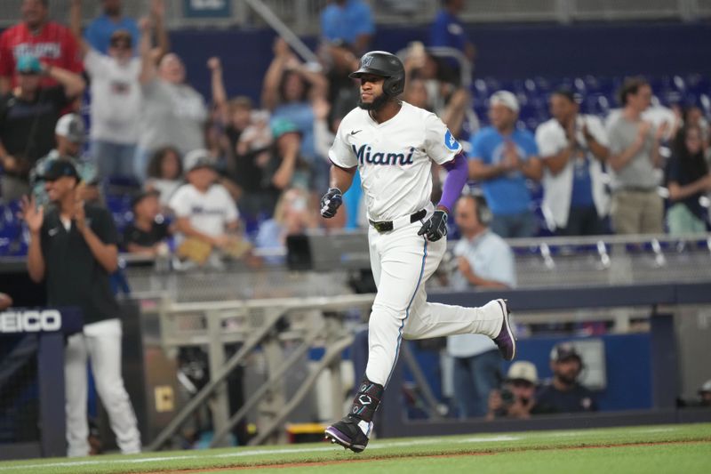 Jun 17, 2024; Miami, Florida, USA;  Miami Marlins designated hitter Bryan De La Cruz (14) rounds the bases after hitting a three-run home run in the eighth inning against the St. Louis Cardinals at loanDepot Park. Mandatory Credit: Jim Rassol-USA TODAY Sports