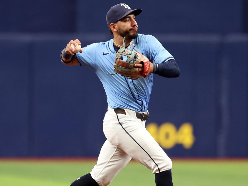 Jul 31, 2024; St. Petersburg, Florida, USA; Tampa Bay Rays shortstop Jose Caballero (7) throws the ball to first base for an out against the Miami Marlins during the eighth inning  at Tropicana Field. Mandatory Credit: Kim Klement Neitzel-USA TODAY Sports