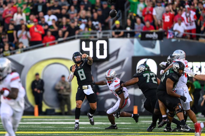 Oct 12, 2024; Eugene, Oregon, USA; Oregon Ducks quarterback Dillon Gabriel (8) throws a pass for a touchdown during the first half against the Ohio State Buckeyes at Autzen Stadium. Mandatory Credit: Craig Strobeck-Imagn Images