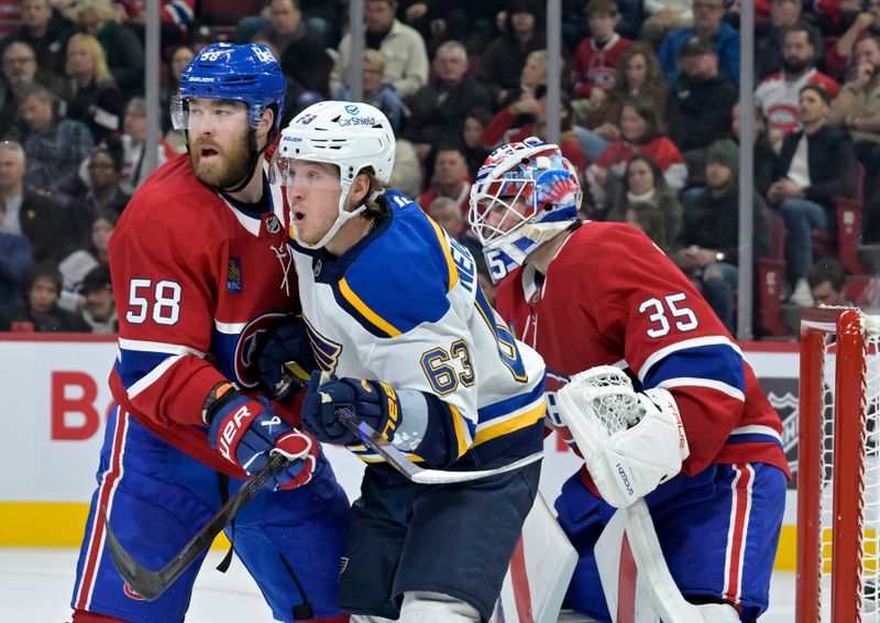 Oct 26, 2024; Montreal, Quebec, CAN; Montreal Canadiens defenseman David Savard (58) moves St.Louis Blues forward Jake Neighbours (63) away from screening  Montreal goalie Sam Montembeault (35) during the second period at the Bell Centre. Mandatory Credit: Eric Bolte-Imagn Images