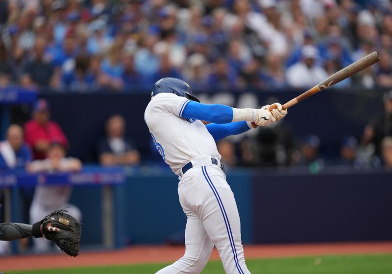 Sep 9, 2023; Toronto, Ontario, CAN; Toronto Blue Jays third baseman Cavan Biggio (8) hits an RBI double against the Kansas City Royals during the sixth inning at Rogers Centre. Mandatory Credit: Nick Turchiaro-USA TODAY Sports