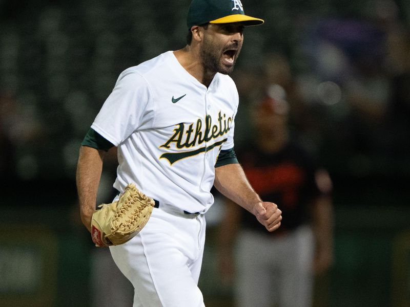 Jul 5, 2024; Oakland, California, USA;  Oakland Athletics pitcher Scott Alexander (54) reacts after striking out a Baltimore Orioles player during the ninth inning at Oakland-Alameda County Coliseum. Mandatory Credit: Stan Szeto-USA TODAY Sports