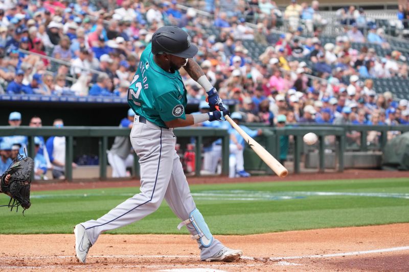 Mar 6, 2024; Surprise, Arizona, USA; Seattle Mariners second baseman Samad Taylor (12) hits a home run against the Kansas City Royals during the third inning at Surprise Stadium. Mandatory Credit: Joe Camporeale-USA TODAY Sports