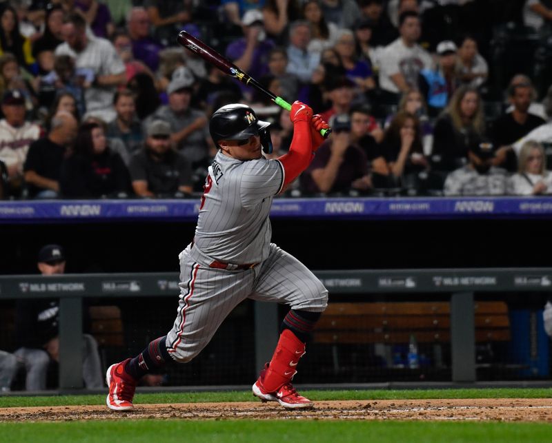 Sep 30, 2023; Denver, Colorado, USA; Minnesota Twins catcher Christian Vazquez (8) singles to right field in the sixth inning against the Colorado Rockies at Coors Field. Mandatory Credit: John Leyba-USA TODAY Sports