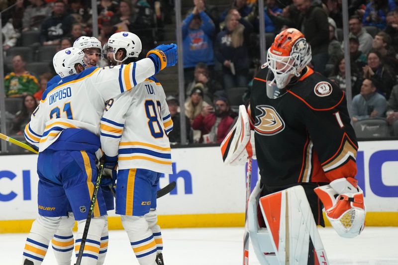 Feb 15, 2023; Anaheim, California, USA; Buffalo Sabres right wing Alex Tuch (89) celebrates with right wing Kyle Okposo (21) and center Dylan Cozens (24) after scoring a goal against Anaheim Ducks goaltender Lukas Dostal (1) in the third period  at Honda Center. Mandatory Credit: Kirby Lee-USA TODAY Sports