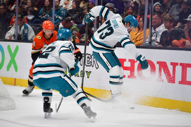 Oct 22, 2024; Anaheim, California, USA;  San Jose Sharks left wing William Eklund (72) and center Tyler Toffoli (73) play for the puck against Anaheim Ducks defenseman Cam Fowler (4) during the first period at Honda Center. Mandatory Credit: Gary A. Vasquez-Imagn Images