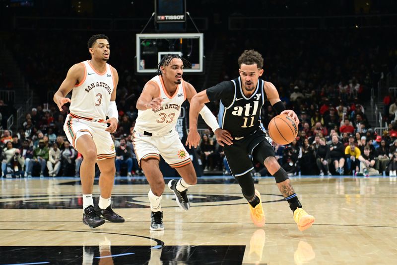 ATLANTA, GA - JANUARY 15: Trae Young #11 of the Atlanta Hawks drives to the basket during the game against the San Antonio Spurs on January 15, 2024 at State Farm Arena in Atlanta, Georgia.  NOTE TO USER: User expressly acknowledges and agrees that, by downloading and/or using this Photograph, user is consenting to the terms and conditions of the Getty Images License Agreement. Mandatory Copyright Notice: Copyright 2024 NBAE (Photo by Adam Hagy/NBAE via Getty Images)