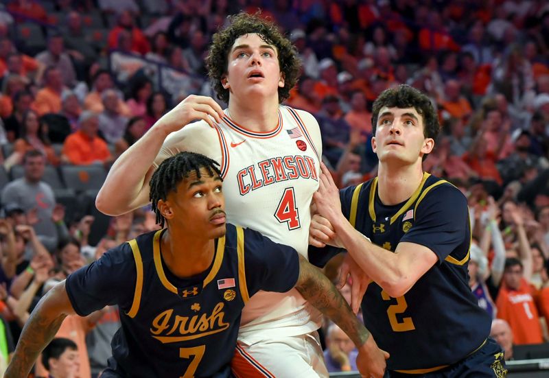 Feb 26, 2025; Clemson, South Carolina, USA; Clemson senior forward Ian Schieffelin (4) watches a free throw sink near Notre Dame forward Tae Davis (7) and Notre Dame guard Logan Imes (2) during the second half at Littlejohn Coliseum. Mandatory Credit: Ken Ruinard-Imagn Images