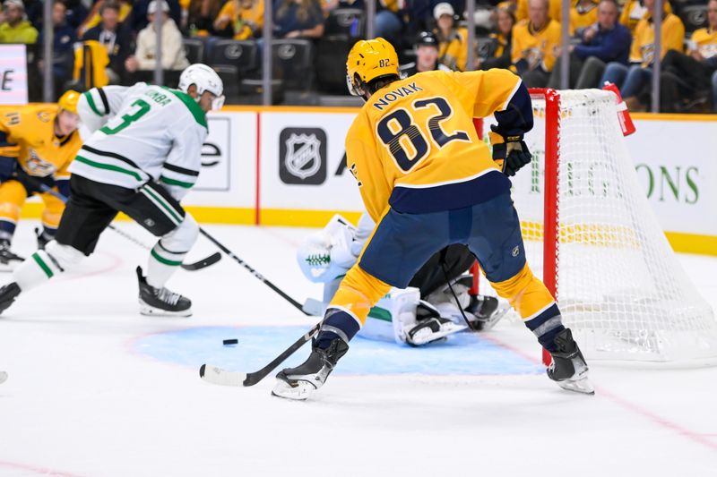 Oct 10, 2024; Nashville, Tennessee, USA;  Nashville Predators center Tommy Novak (82) misses a shot on goal against the Dallas Stars during the third period at Bridgestone Arena. Mandatory Credit: Steve Roberts-Imagn Images