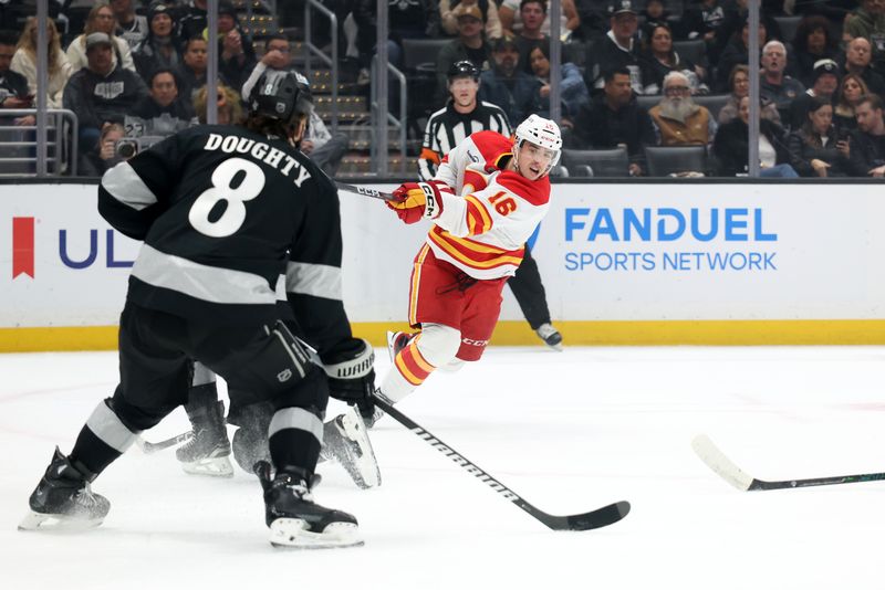 Dec 13, 2025; Los Angeles, California, USA;  Calgary Flames center Morgan Frost (16) shoots the puck against Los Angeles Kings defenseman Drew Doughty (8) during the first period at Crypto.com Arena. Mandatory Credit: Kiyoshi Mio-Imagn Images