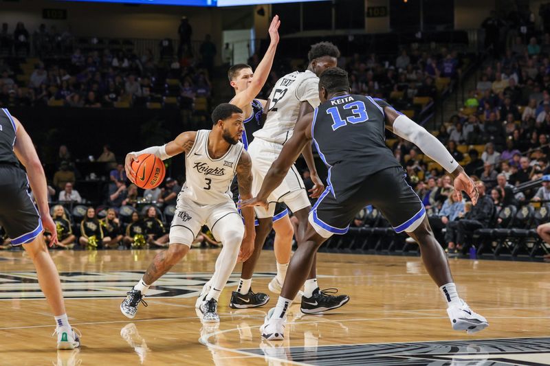 Feb 1, 2025; Orlando, Florida, USA; UCF Knights guard Darius Johnson (3) moves the ball during the first half against the Brigham Young Cougars at Addition Financial Arena. Mandatory Credit: Mike Watters-Imagn Images