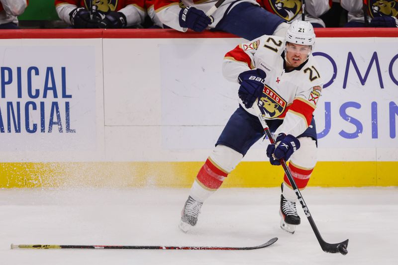 Mar 21, 2024; Sunrise, Florida, USA; Florida Panthers center Nick Cousins (21) moves the puck against the Nashville Predators during the third period at Amerant Bank Arena. Mandatory Credit: Sam Navarro-USA TODAY Sports