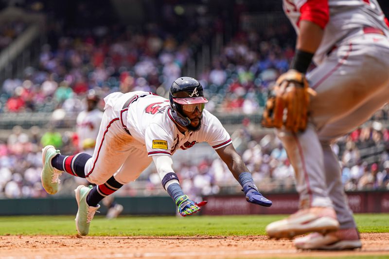 Aug 2, 2023; Cumberland, Georgia, USA; Atlanta Braves center fielder Michael Harris II (23) slides into third base against the Los Angeles Angels during the sixth inning at Truist Park. Mandatory Credit: Dale Zanine-USA TODAY Sports