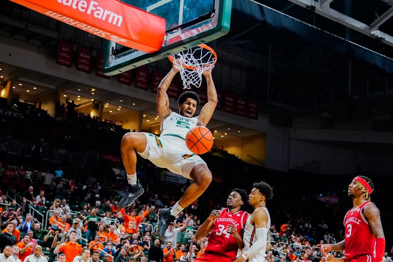 Feb 11, 2023; Coral Gables, Florida, USA; Miami (Fl) Hurricanes guard Harlond Beverly (5) dunks the ball against the Louisville Cardinals during the second half at Watsco Center. Mandatory Credit: Rich Storry-USA TODAY Sports