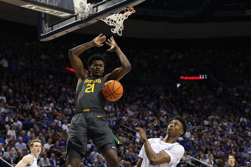 Feb 20, 2024; Provo, Utah, USA; Baylor Bears center Yves Missi (21) dunks the ball over Brigham Young Cougars guard Jaxson Robinson (2) during the first half at Marriott Center. Mandatory Credit: Rob Gray-USA TODAY Sports