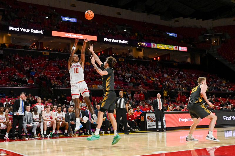 Feb 14, 2024; College Park, Maryland, USA;  Maryland Terrapins forward Julian Reese (10) shoots over Iowa Hawkeyes forward Owen Freeman (32) during the second half at Xfinity Center. Mandatory Credit: Tommy Gilligan-USA TODAY Sports