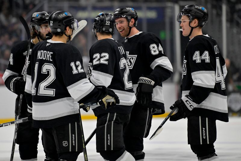 Nov 16, 2024; Los Angeles, California, USA; Los Angeles Kings center Phillip Danault (24), left wing Trevor Moore (12),  left wing Kevin Fiala (22), defenseman Vladislav Gavrikov (84) and defenseman Mikey Anderson (44) on the ice during a break in play in the second period against the Detroit Red Wings at Crypto.com Arena. Mandatory Credit: Jayne Kamin-Oncea-Imagn Images