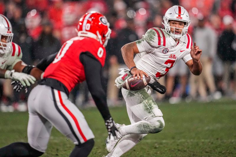 Nov 11, 2023; Athens, Georgia, USA; A Mississippi Rebels quarterback Spencer Sanders (3) tries to escape the pressure from Georgia Bulldogs linebacker Troy Bowles (0) during the second half at Sanford Stadium. Mandatory Credit: Dale Zanine-USA TODAY Sports