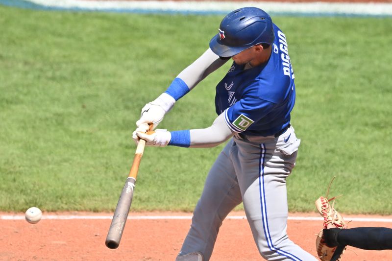 Aug 10, 2023; Cleveland, Ohio, USA; Toronto Blue Jays second baseman Cavan Biggio (8) hits a single during the seventh inning against the Cleveland Guardians at Progressive Field. Mandatory Credit: Ken Blaze-USA TODAY Sports