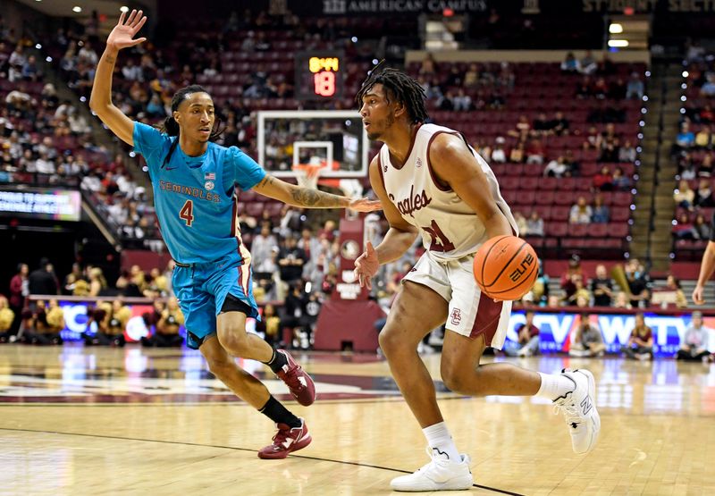 Feb 18, 2023; Tallahassee, Florida, USA; Boston College Eagles forward Devin McGlockton (21) drives to the net past the defense of Florida State Seminoles guard Caleb Mills (4) during the first half at Donald L. Tucker Center. Mandatory Credit: Melina Myers-USA TODAY Sports