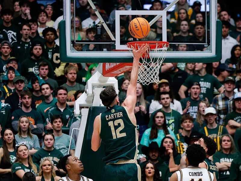 Mar 2, 2024; Fort Collins, Colorado, USA; Colorado State Rams forward Patrick Cartier (12) drives to the net against Wyoming Cowboys forward Cam Manyawu (5) and guard Kael Combs (11) in the second half at Moby Arena. Mandatory Credit: Isaiah J. Downing-USA TODAY Sports