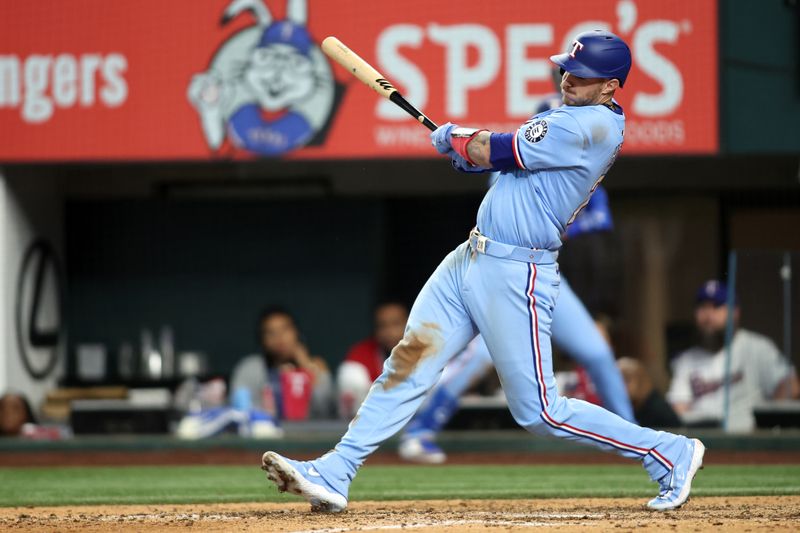 Apr 6, 2025; Arlington, Texas, USA; Texas Rangers catcher Jonah Heim (28) singles in the winning run in the bottom of the ninth inning against the Tampa Bay Rays at Globe Life Field. Mandatory Credit: Tim Heitman-Imagn Images