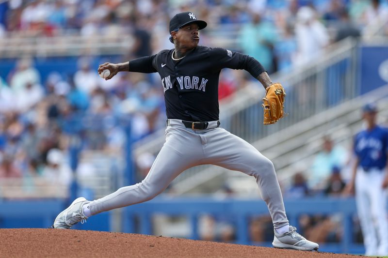 Mar 8, 2024; Dunedin, Florida, USA;  New York Yankees starting pitcher Marcus Stroman (0) throws a pitch against the Toronto Blue Jays in the first inning at TD Ballpark. Mandatory Credit: Nathan Ray Seebeck-USA TODAY Sports