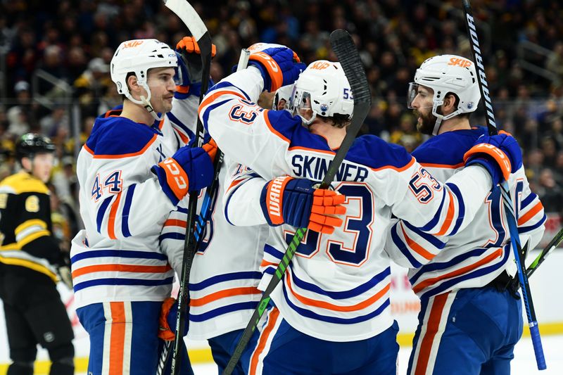 Jan 7, 2025; Boston, Massachusetts, USA;  Edmonton Oilers defenseman Joshua Brown (44) left wing Zach Hyman (18) wing Viktor Arvidsson (33) celebrate a goal by center Adam Henrique (19) during the second period against the Boston Bruins at TD Garden. Mandatory Credit: Bob DeChiara-Imagn Images