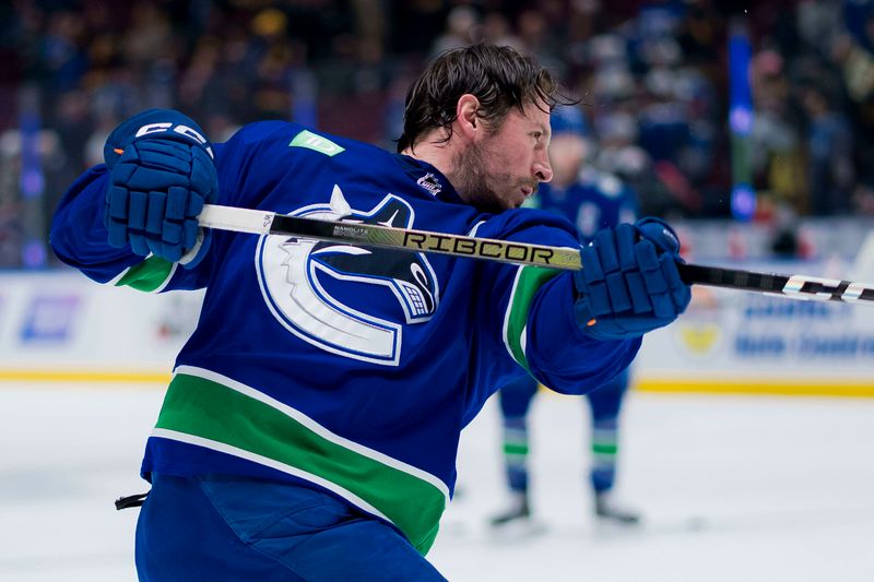 Mar 13, 2024; Vancouver, British Columbia, CAN; Vancouver Canucks forward J.T. Miller (9) shoots during warm up prior to a game against the Colorado Avalanche at Rogers Arena. Mandatory Credit: Bob Frid-USA TODAY Sports