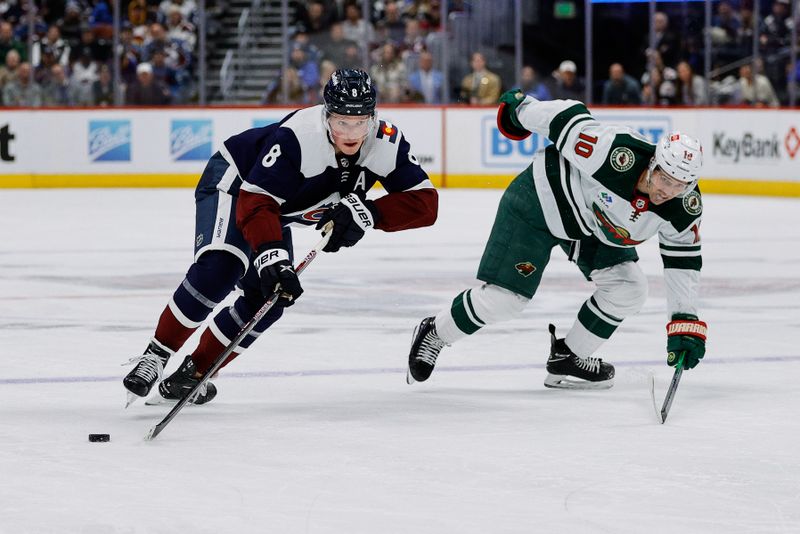 Mar 8, 2024; Denver, Colorado, USA; Colorado Avalanche defenseman Cale Makar (8) controls the puck against Minnesota Wild center Vinni Lettieri (10) in the second period at Ball Arena. Mandatory Credit: Isaiah J. Downing-USA TODAY Sports