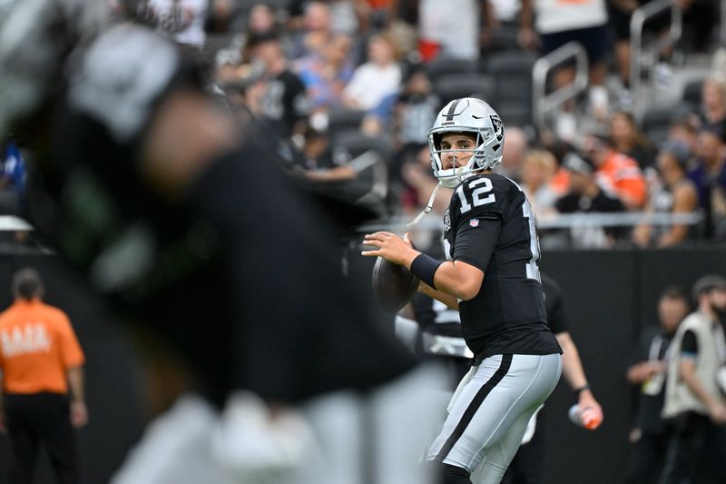 Las Vegas Raiders quarterback Aidan O'Connell warms up before an NFL football game against the Cleveland Browns Sunday, Sept. 29, 2024, in Las Vegas. (AP Photo/David Becker)