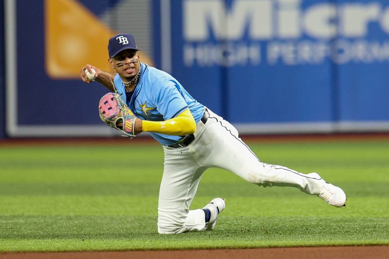 Aug 12, 2024; St. Petersburg, Florida, USA; Tampa Bay Rays second baseman Christopher Morel (24) fields the ball against the Houston Astros in the fifth inning at Tropicana Field. Mandatory Credit: Nathan Ray Seebeck-USA TODAY Sports