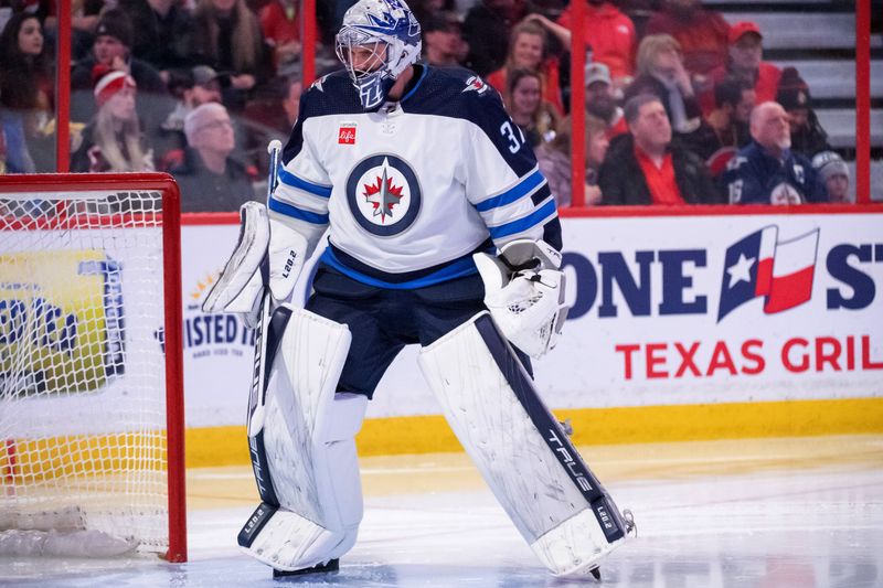 Jan 21, 2023; Ottawa, Ontario, CAN; Winnipeg Jets goalie Connor Hellebuyck (37) warms up prior to the start against the Ottawa Senators at the Canadian Tire Centre. Mandatory Credit: Marc DesRosiers-USA TODAY Sports