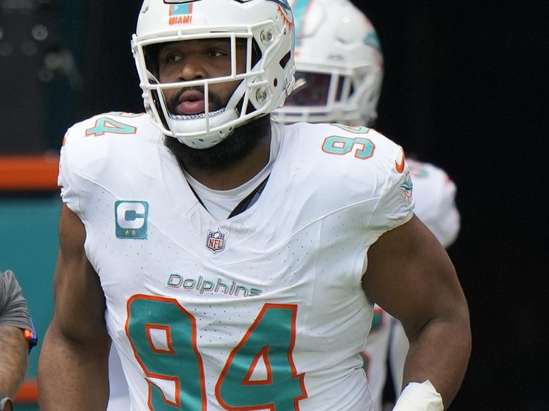 Miami Dolphins defensive tackle Christian Wilkins (94) hits the field to warm up before the start of an NFL football game against the Denver Broncos, Sunday, Sept. 24, 2023, in Miami Gardens, Fla. (AP Photo/Wilfredo Lee)