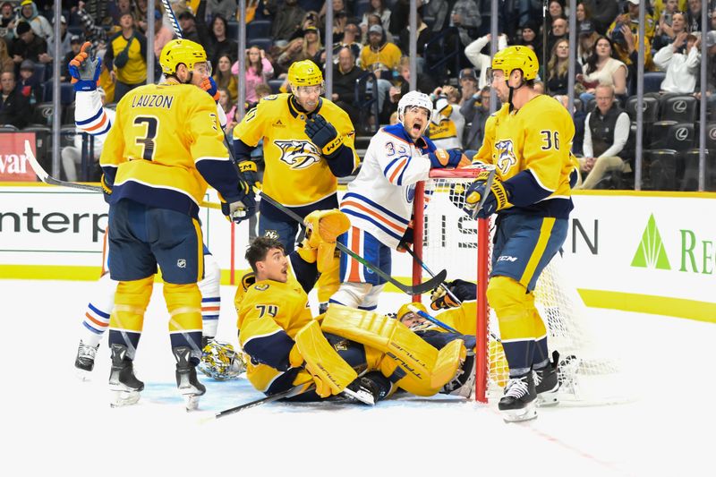 Oct 17, 2024; Nashville, Tennessee, USA;  Edmonton Oilers center Jeff Skinner (53) scores past Nashville Predators goaltender Juuse Saros (74) as left wing Viktor Arvidsson (33) celebrates during the second period at Bridgestone Arena. Mandatory Credit: Steve Roberts-Imagn Images