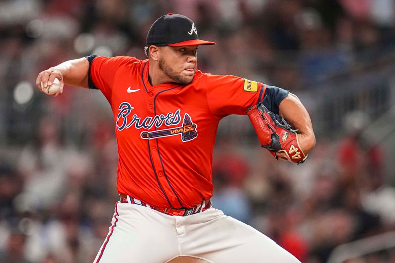 Aug 2, 2024; Cumberland, Georgia, USA; Atlanta Braves relief pitcher Joe Jimenez (77) pitches against the Miami Marlins during the ninth inning at Truist Park. Mandatory Credit: Dale Zanine-USA TODAY Sports