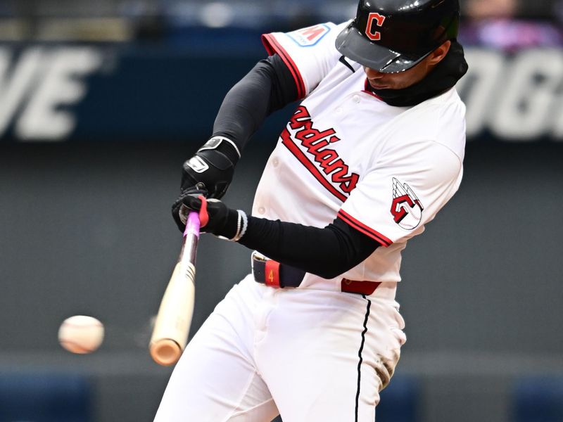Apr 10, 2025; Cleveland, Ohio, USA; Cleveland Guardians shortstop Brayan Rocchio (4) hits a single during the eighth inning against the Chicago White Sox at Progressive Field. Mandatory Credit: Ken Blaze-Imagn Images